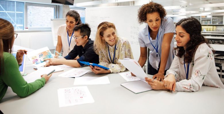 Lab and support staff hold a meeting