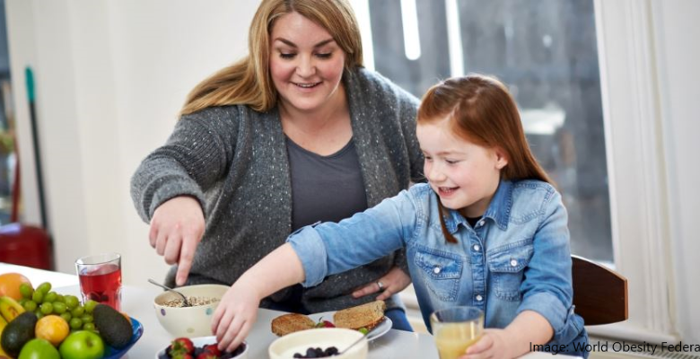 a mother and daughter select healthy foods from a selection of fruits and grains